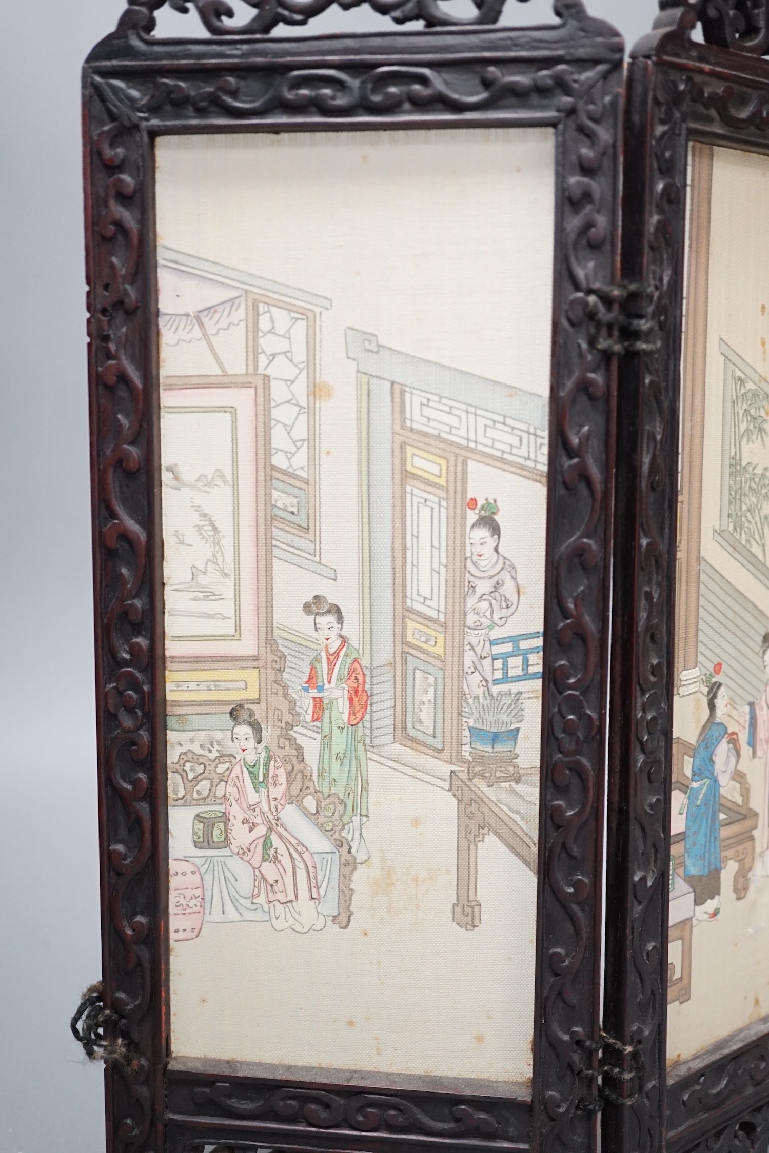 A Chinese hardwood framed painted silk four fold miniature screen, inset with painted silk panels, 28cm